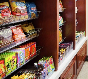 A snack aisle with various packaged snacks and chips. - Hilton Garden Inn Virginia Beach Town Center (Virginia Beach)