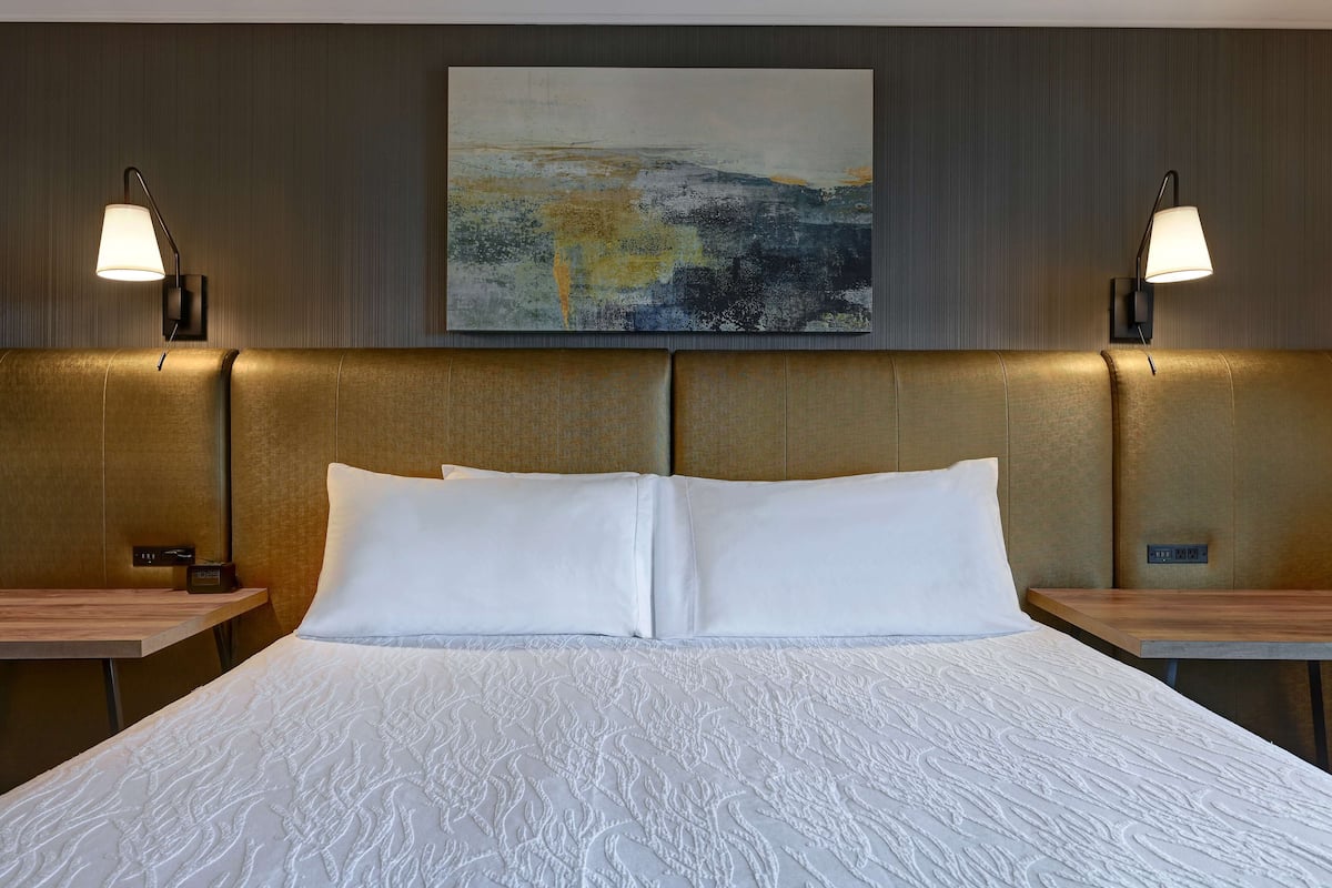 suite, 1 king bed, jetted tub | in-room safe, desk, iron/ironing board, rollaway beds