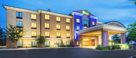 A hotel with a modern design, featuring a large entrance and multiple windows.