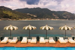 Seasonal outdoor pool, open 9 AM to 7 PM, pool umbrellas, pool loungers