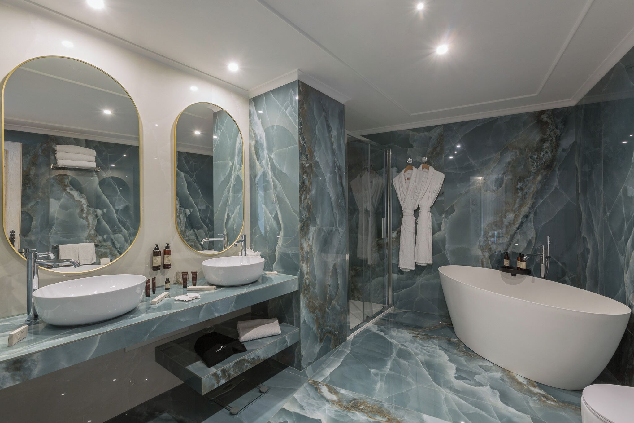 designer toiletries, hair dryer, bathrobes, slippers