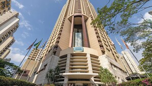 Un edificio alto y moderno con fachada curva y varios balcones.