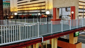 A Hard Rock building with a pedestrian bridge, a Motor Inn sign, and a visible storefront. - Atlantic Motor Inn (Atlantic City)