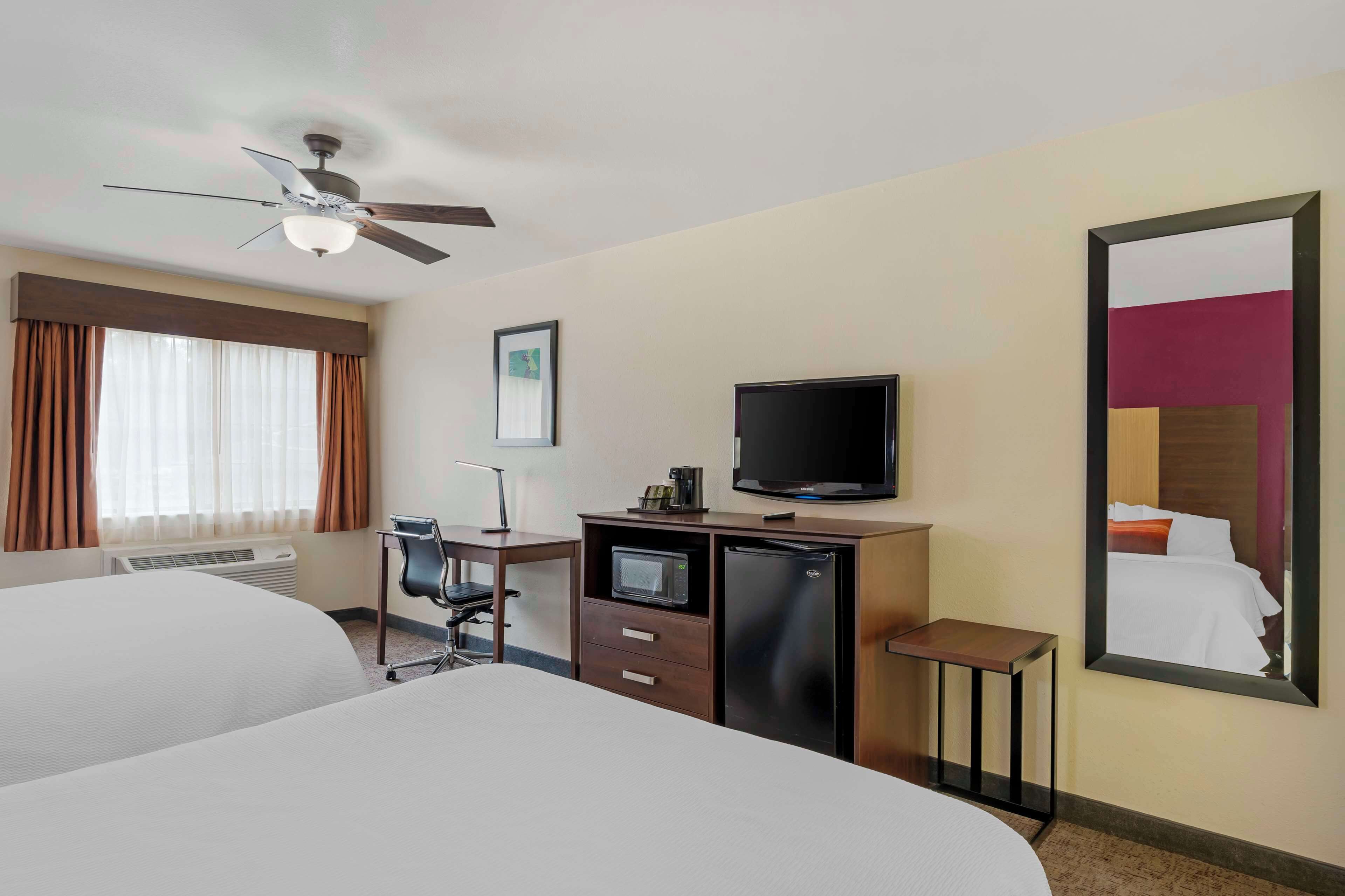 standard room, 2 queen beds, non smoking, refrigerator & microwave | in-room safe, desk, laptop workspace, iron/ironing board