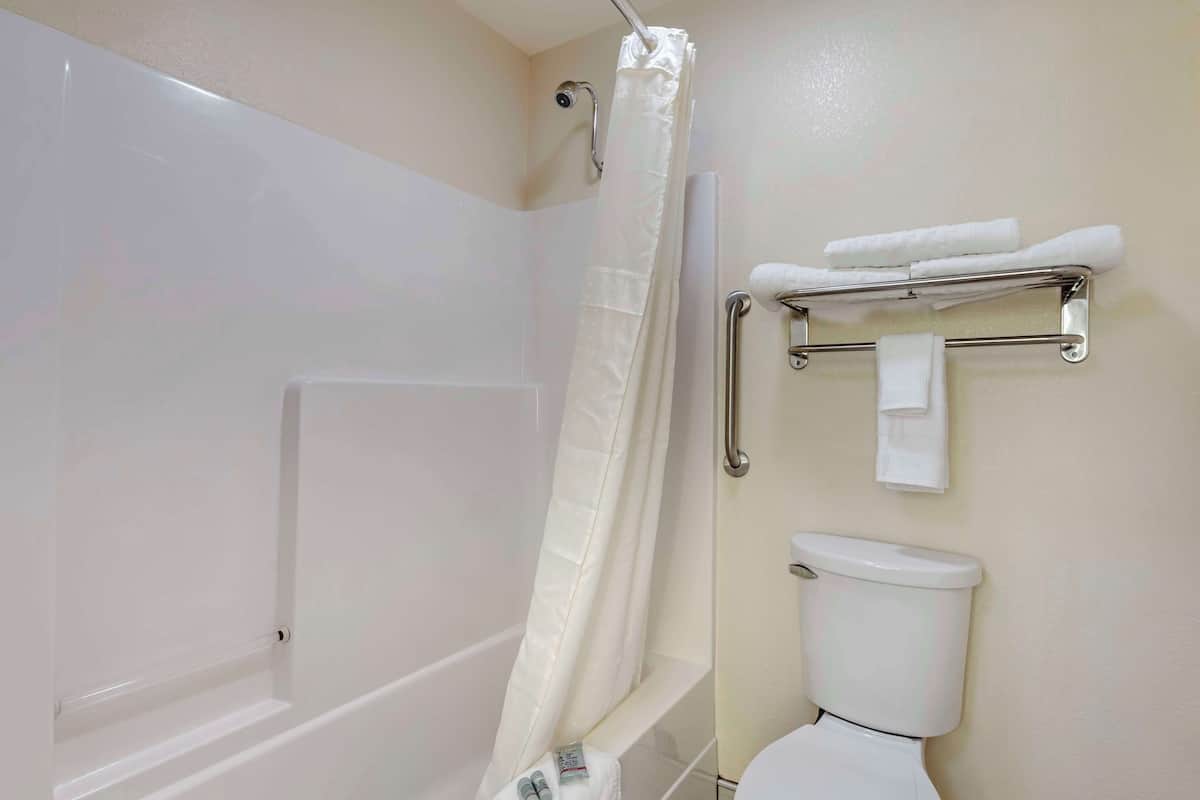 standard room, 2 queen beds, non smoking, refrigerator & microwave | bathroom | combined shower/bathtub, free toiletries, hair dryer, towels