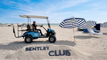 On the beach, white sand, beach cabanas, beach umbrellas