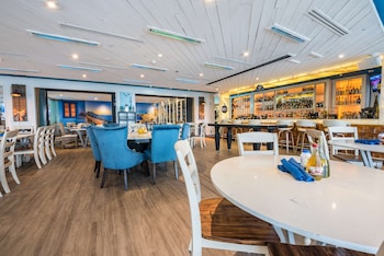 A spacious lobby with a polished floor, large glass doors leading outside, and a reception area with a counter. at Hilton Bentley Miami/South Beach