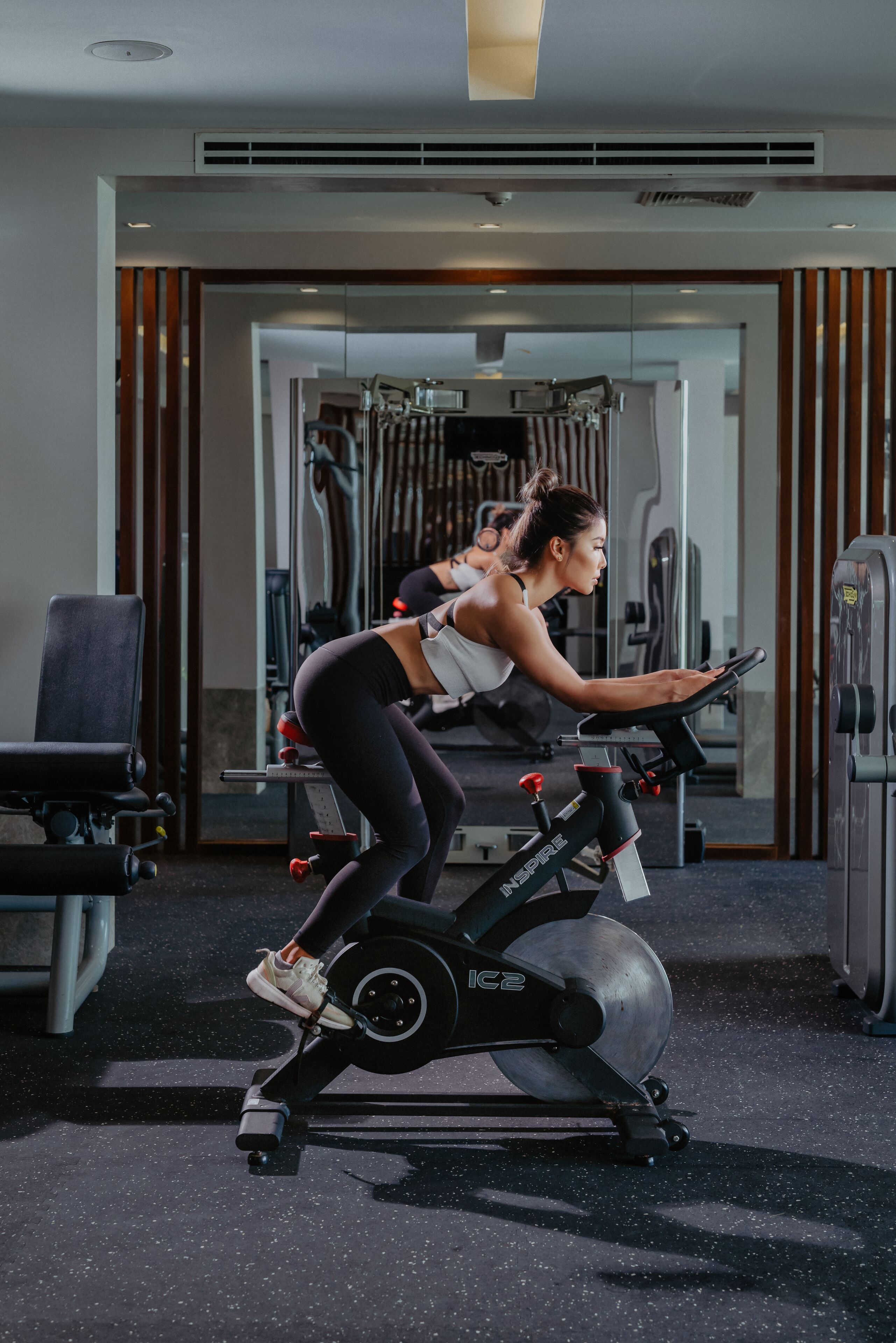 A gym with exercise equipment, including a stationary bike and weights.