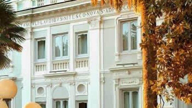 Un edificio clásico de fachada simétrica, con ventanas grandes y una entrada central.