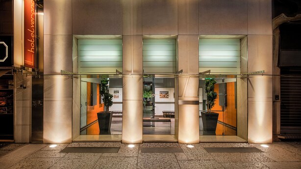 A hotel entrance with a modern design, featuring a glass facade and a sign that reads "hotelverona". - Hotel Verona (Verona)