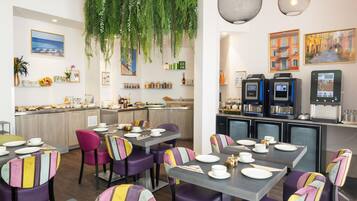 A restaurant interior with tables set for dining, a bar area, and a coffee machine.