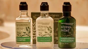 Three bottles of Bath & Body Works products: shampoo, conditioner, and body lotion.