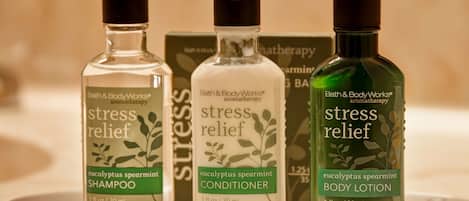 Three bottles of Bath & Body Works products: shampoo, conditioner, and body lotion.