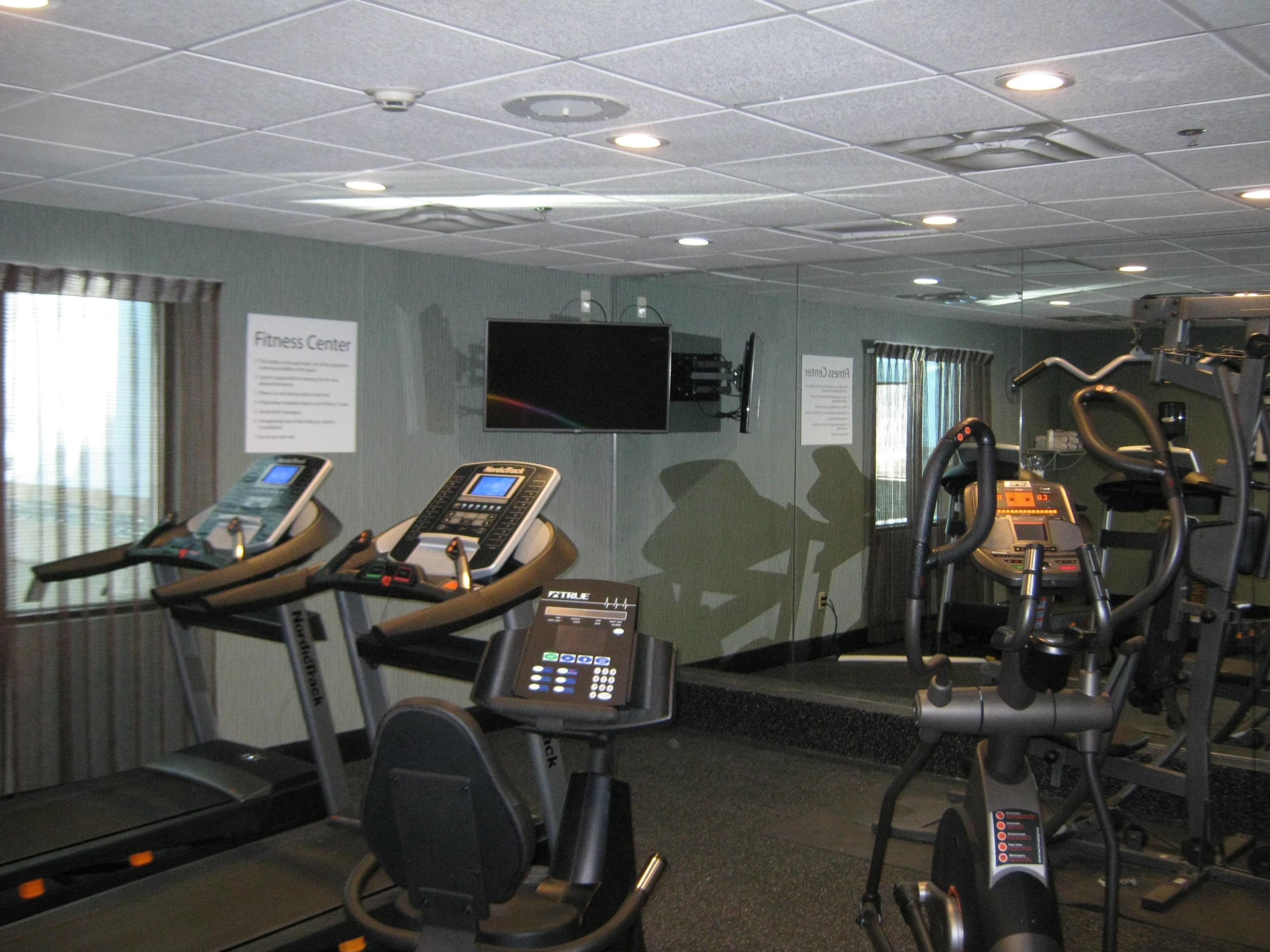 A fitness center with treadmills, an elliptical, and a stationary bike.