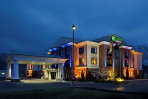 A Holiday Inn Express hotel with a covered parking area and a well-lit entrance. - Holiday Inn Express & Suites North Lima by IHG (North Lima)