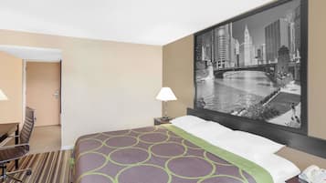 A hotel room with a bed, a desk, a chair, a lamp, and a large cityscape painting on the wall.