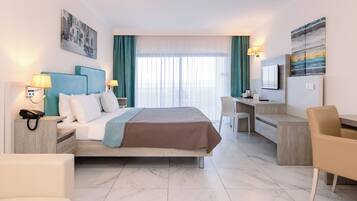 A hotel room with a bed, desk, chair, and a television.