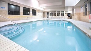An indoor swimming pool with clear water, tiled walls, and a tiled deck area. - Country Inn & Suites by Radisson, Stone Mountain, GA (Stone Mountain)