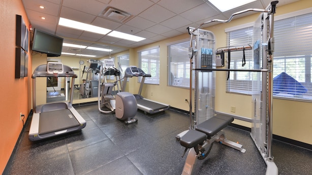 A gym with treadmills, elliptical machines, and weightlifting equipment. - Country Inn & Suites by Radisson, Stone Mountain, GA (Stone Mountain)