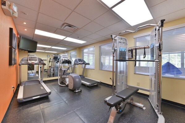 A gym with treadmills, elliptical machines, and weightlifting equipment. - Country Inn & Suites by Radisson, Stone Mountain, GA (Stone Mountain)