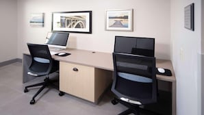 A modern office space with two desks, each with a computer and a chair. There are framed pictures on the wall. - Country Inn & Suites by Radisson, Stone Mountain, GA (Stone Mountain)