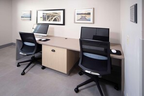 A modern office space with two desks, each with a computer and a chair. There are framed pictures on the wall. - Country Inn & Suites by Radisson, Stone Mountain, GA (Stone Mountain)