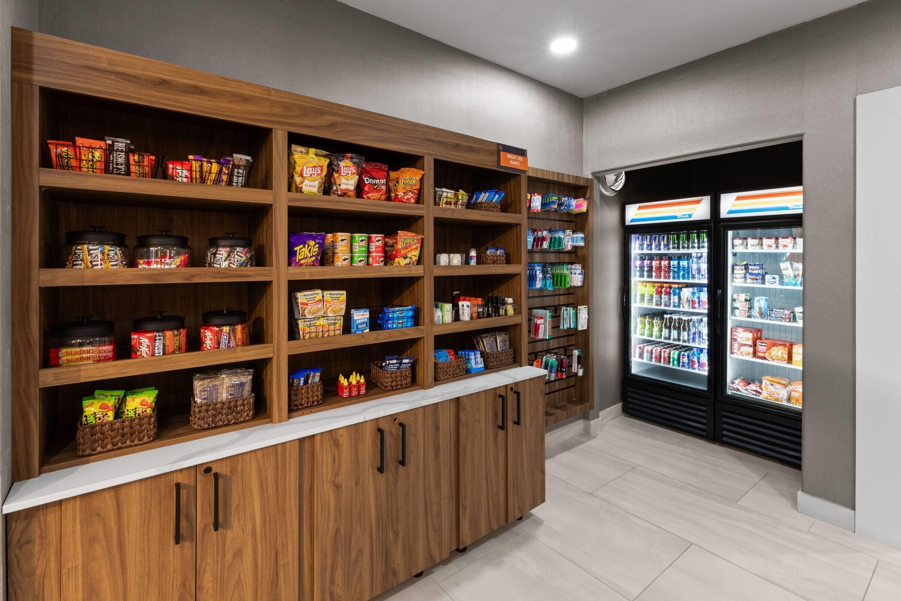 Un kiosque proposant des collations et des boissons, avec plusieurs étagères remplies de divers en-cas et boissons.
