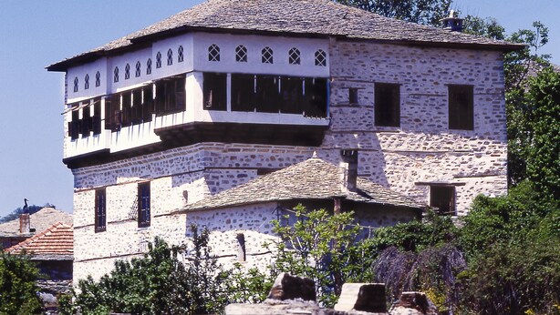 A stone building with a central tower and multiple windows. - Santikos Mansion (South Pelion)