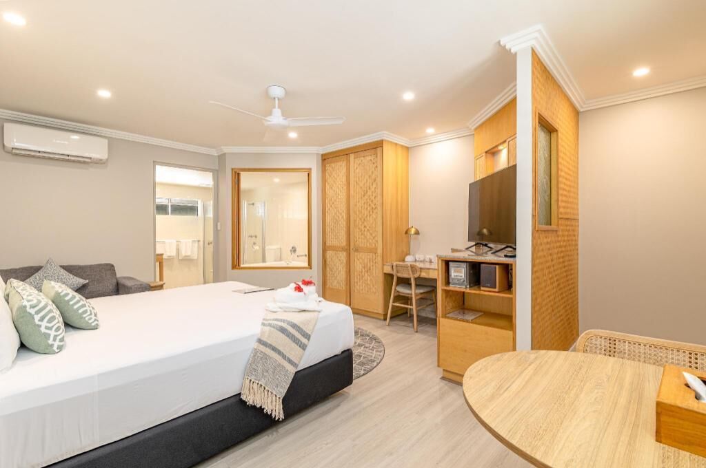 Desk, laptop workspace, bed sheets
