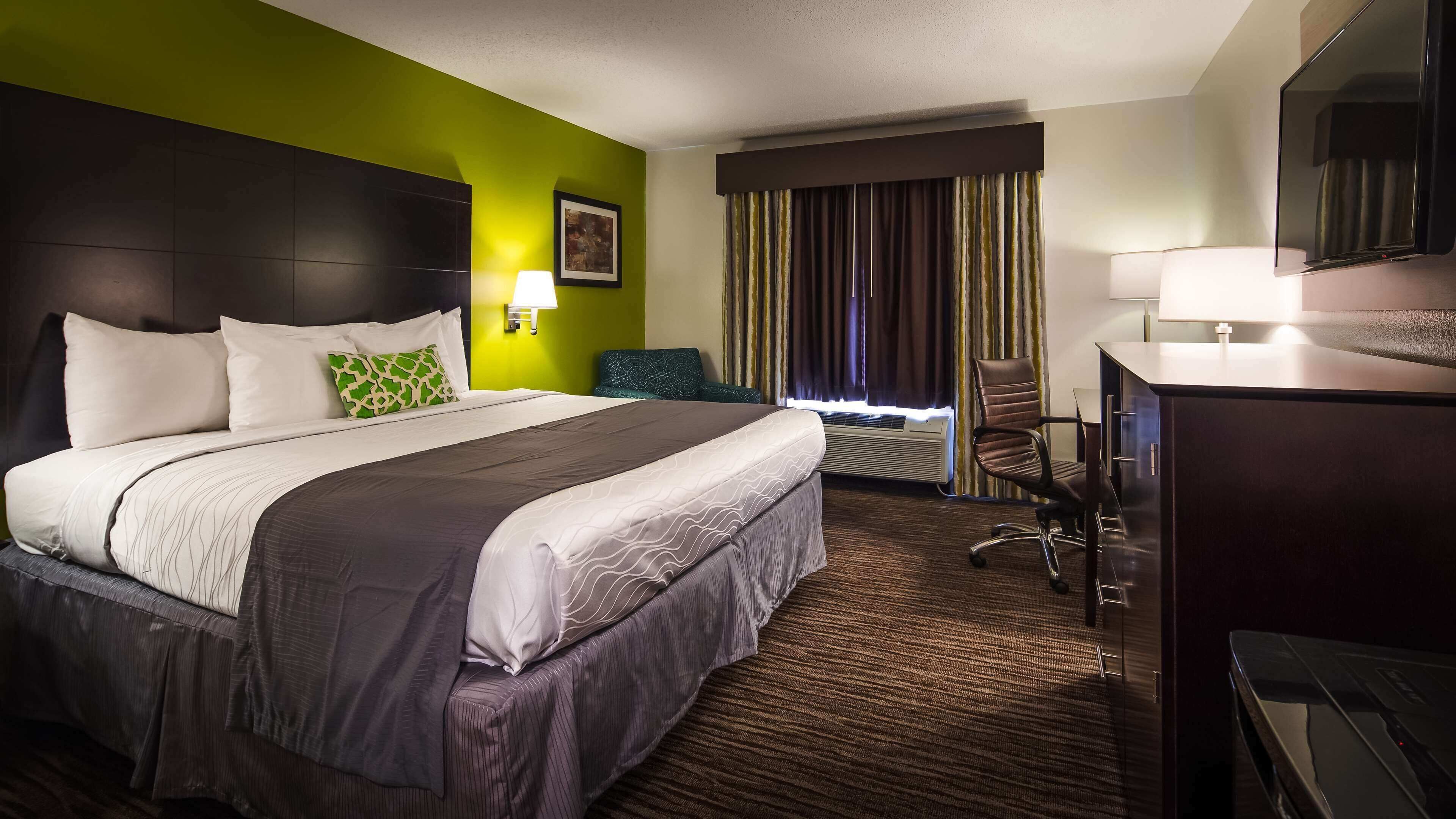 Premium bedding, desk, laptop workspace, blackout drapes