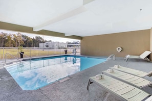 Seasonal outdoor pool, open 8:00 AM to 10:00 PM, pool umbrellas