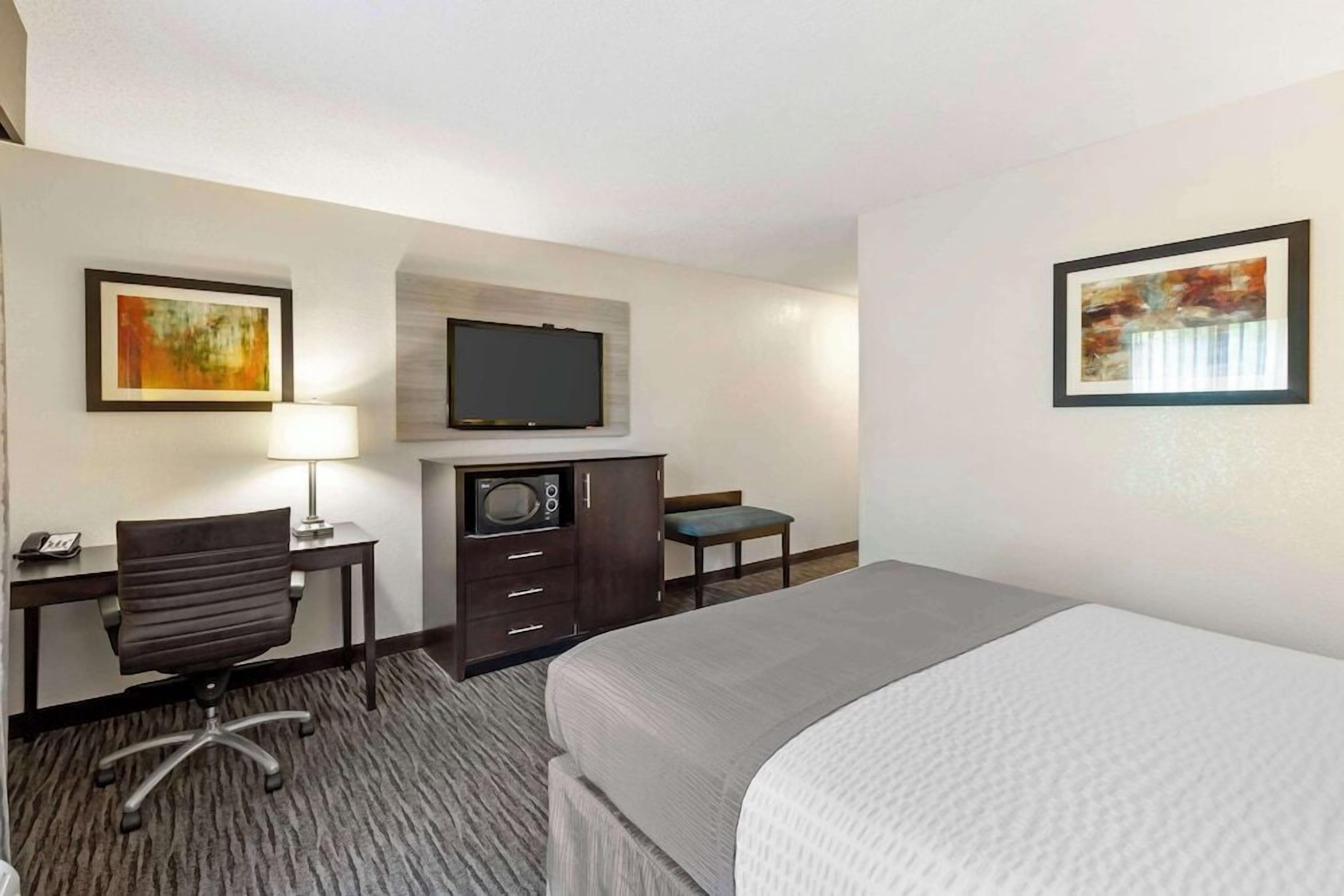 Premium bedding, desk, laptop workspace, blackout drapes
