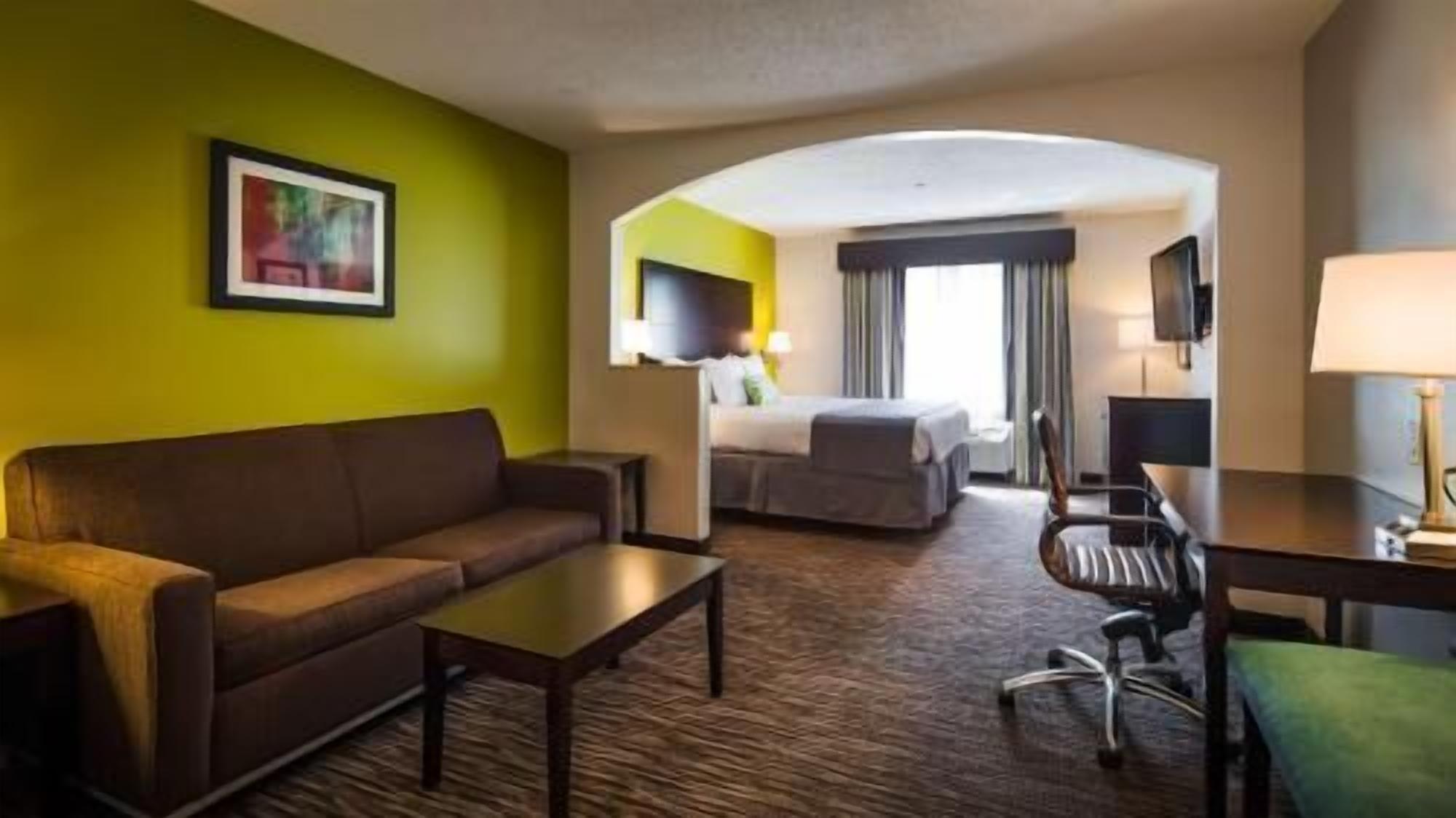 Premium bedding, desk, laptop workspace, blackout drapes