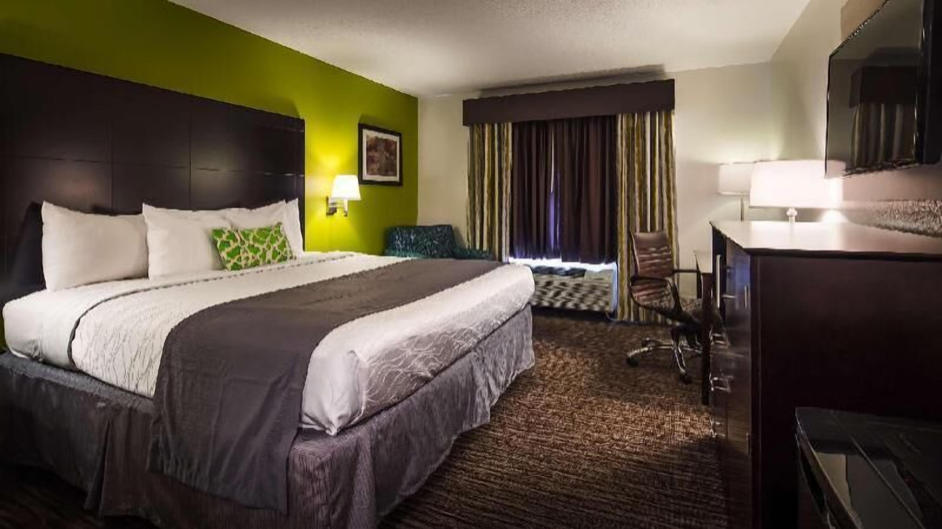 Premium bedding, desk, laptop workspace, blackout drapes