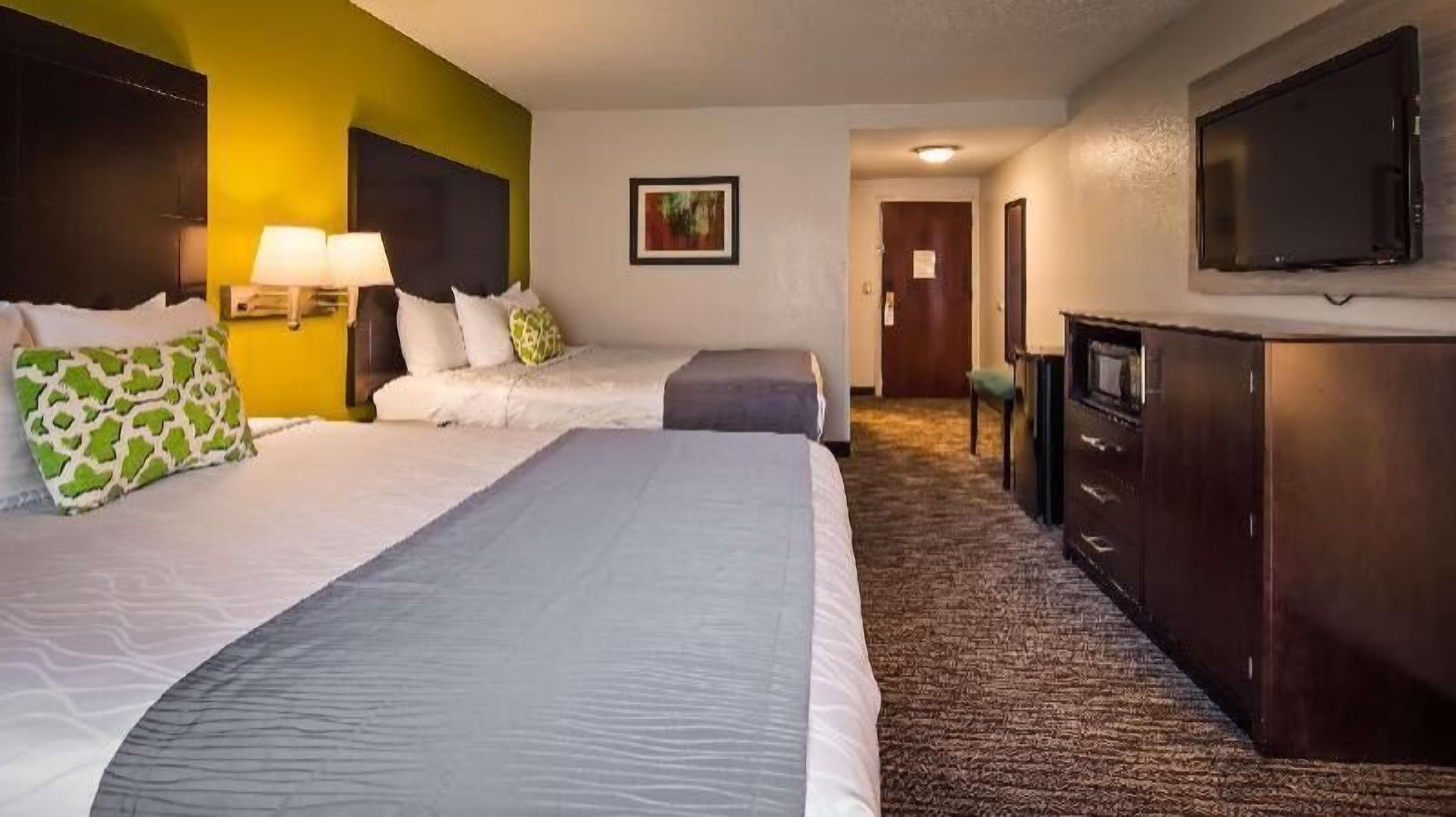 Premium bedding, desk, laptop workspace, blackout drapes