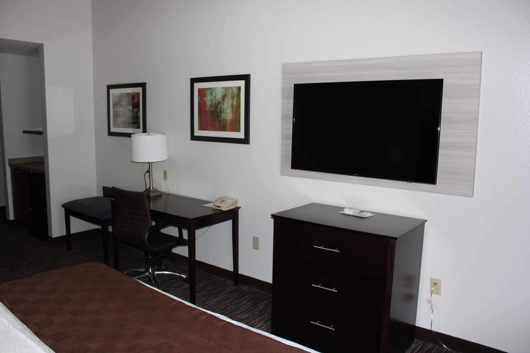 Premium bedding, desk, laptop workspace, blackout drapes