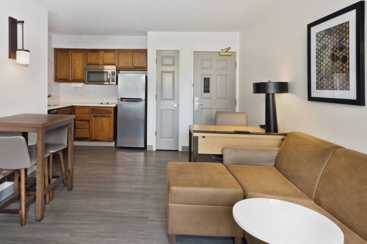 A compact living space with a kitchenette, a dining area, and a seating area.