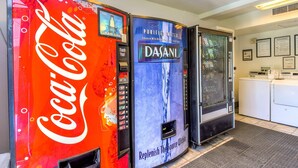Two beverage dispensers, one Coca-Cola and one Dasani, in a hotel lobby. - Motel 6 Corona, CA (Corona)