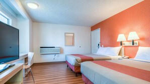 A hotel room with two beds, a desk, a TV, and a window. - Motel 6 Rowland Heights, CA - Los Angeles - Pomona (Rowland Heights)