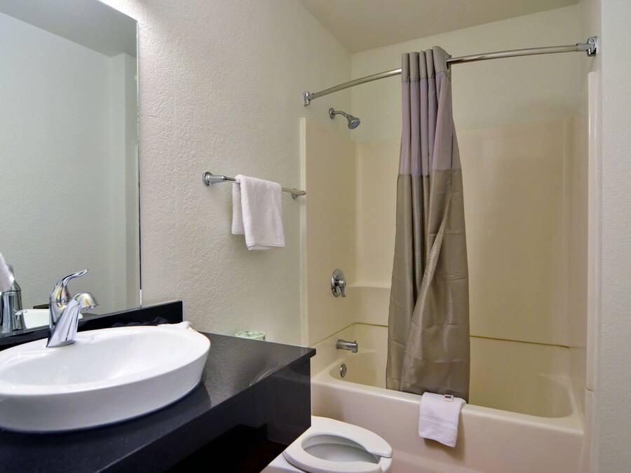 A bathroom with a sink, toilet, and bathtub.