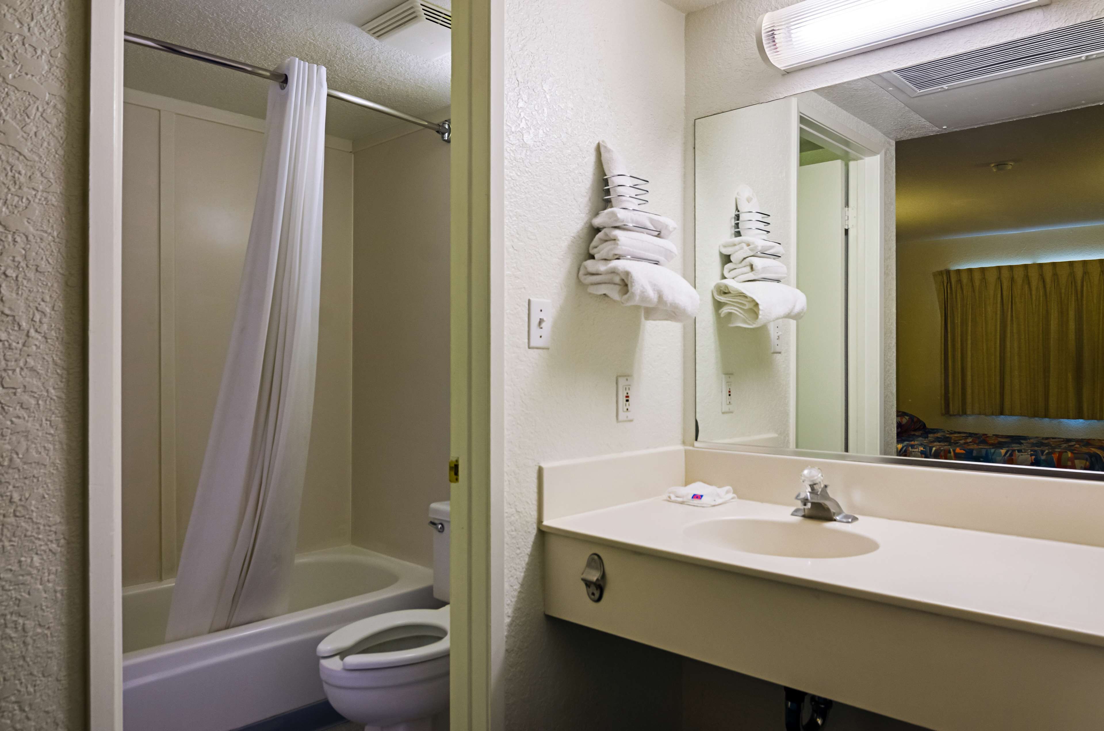 A bathroom with a shower, toilet, and sink.