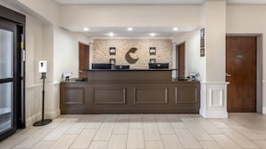 A reception area with a counter, a wall-mounted clock, and a door labeled "Private."