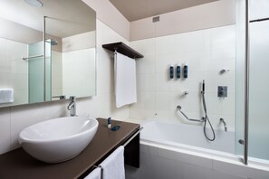 A modern bathroom with a white sink, a bathtub, and a glass shower enclosure. - Four Points by Sheraton Bolzano (Bolzano)