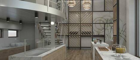 A modern interior with a central staircase, wooden flooring, and a marble counter with food items.