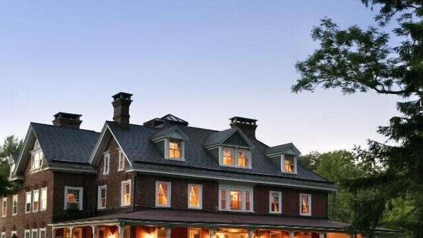 A large, multi-story brick building with a prominent front porch and multiple windows. - Cameron Estate Inn & Restaurant (Mount Joy)