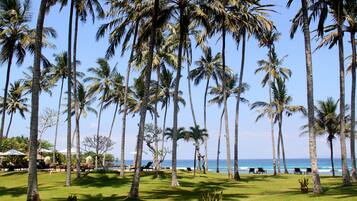 On the beach, white sand, beach umbrellas, beach towels