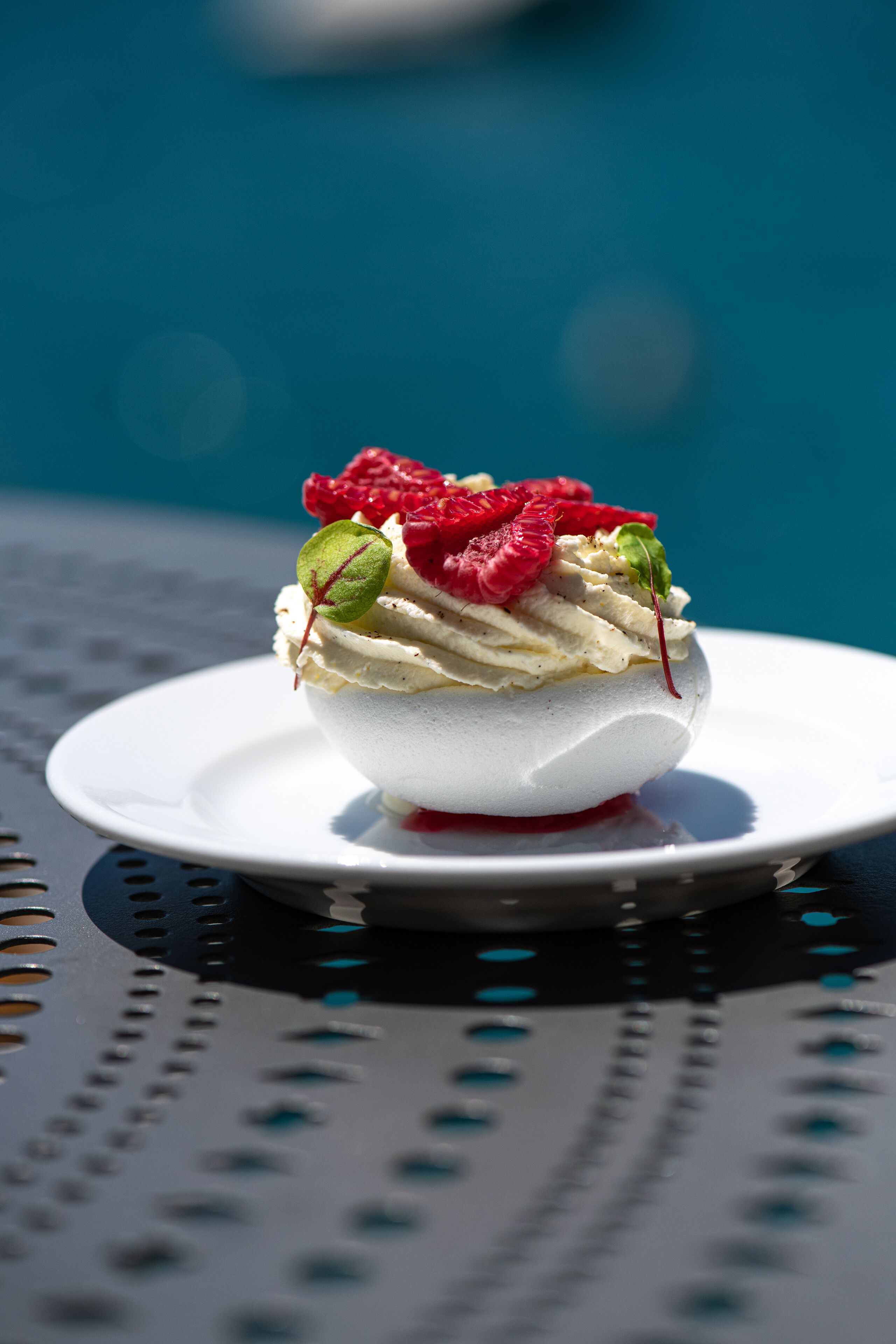 A dessert on a white plate with a blue background.