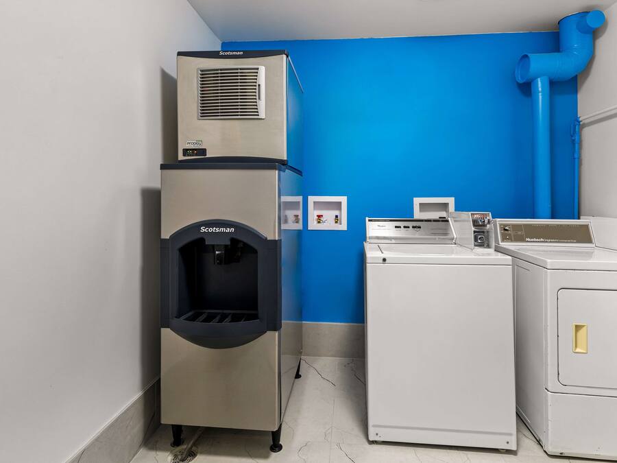 A laundry room with a Scotman ice maker, a washing machine, and a dryer.