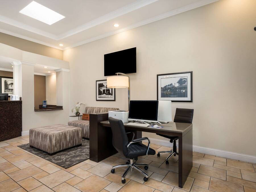 A modern office space with a desk, office chair, and a flat-screen monitor.
