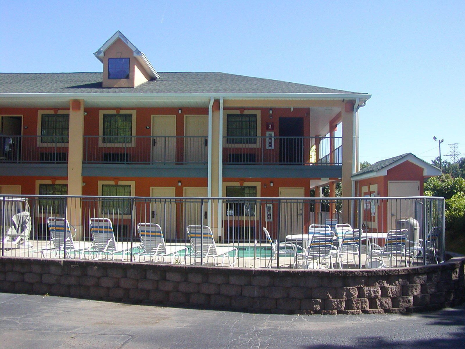 A two-story motel with a pool area.